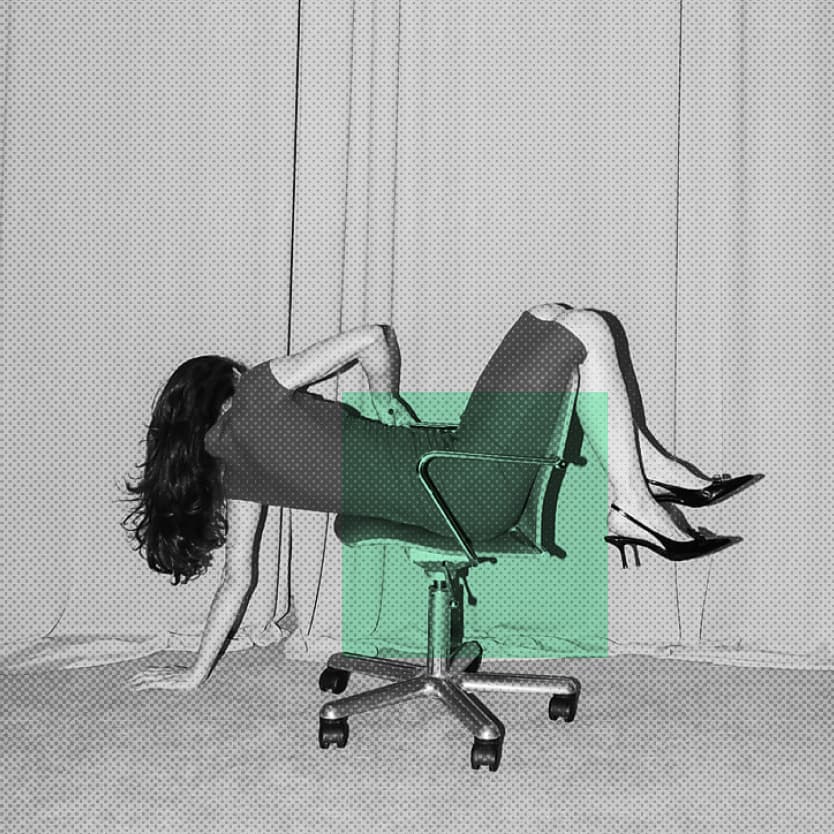 Conceptual black and white photo of a tired person slumped forward with their face on a laptop at a café table, exhaustion theme with orange square overlay